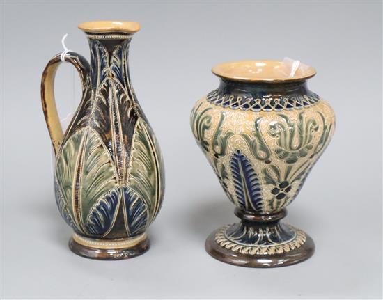 A Doulton Lambeth leaf incised jug, dated 1877, by Elizabeth A Gadson & Fanny Clark and a similar foliate ogee-shaped vase, signed EB,